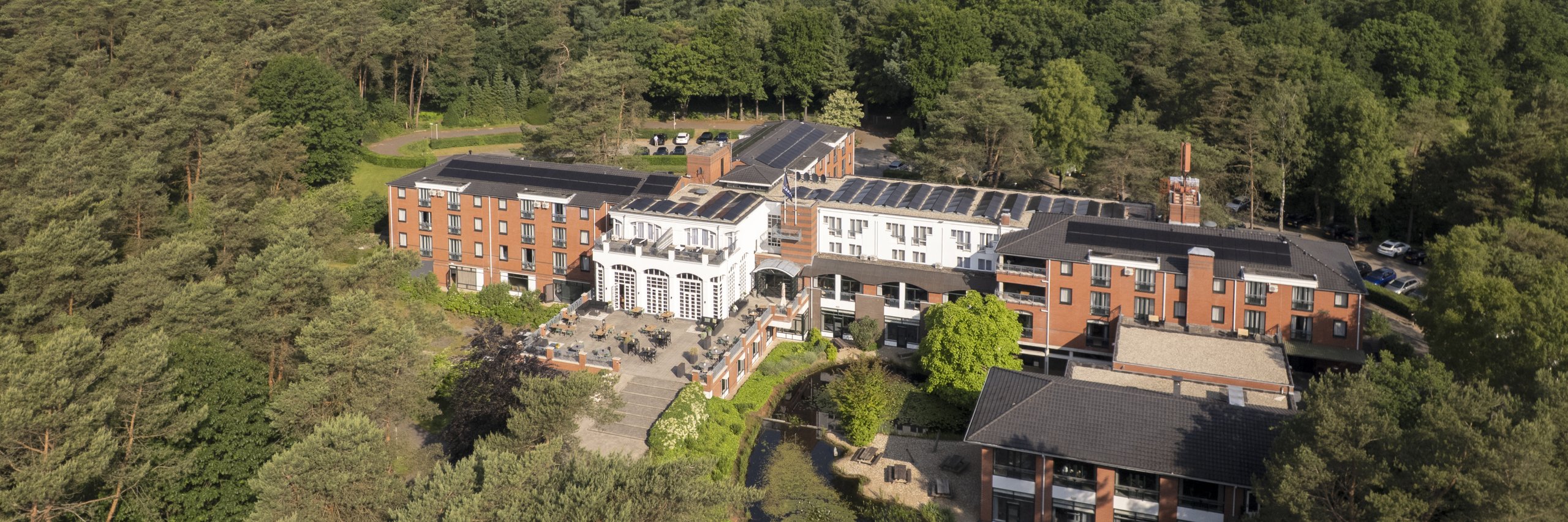 Luchtfoto van Residence Heideborgh in Garderen, gelegen te midden van uitgestrekte bossen op de Veluwe.